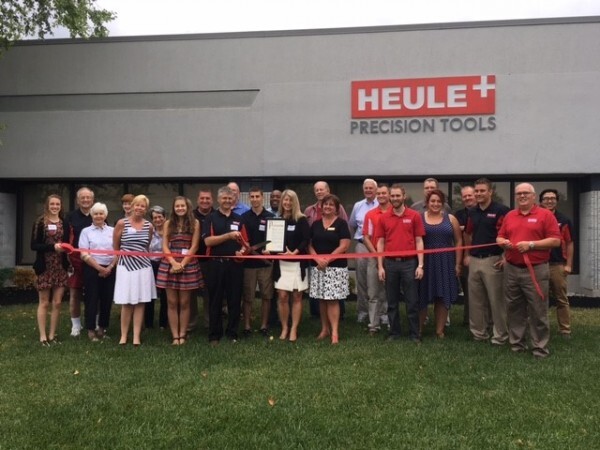 Open House, group cutting red ribbon